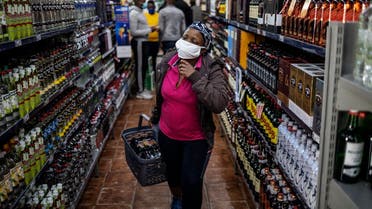 A customer buys alcohol at a liquor shop at the Bara taxi rank in Soweto, Johannesburg. (AFP)