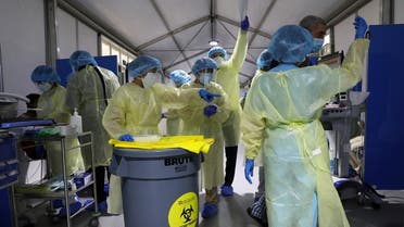 Members of medical staff wearing protective equipment work during testing, amid the coronavirus disease (COVID-19) outbreak, at the Cleveland Clinic hospital in Abu Dhabi. (Reuters)