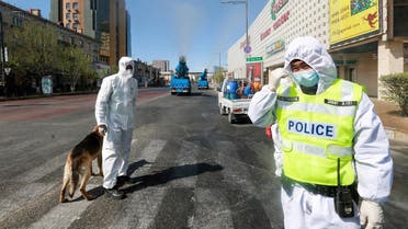 Staff members and police officers wear hazmat suits as they take part in a drill to prepare for the COVID-19 coronavirus in Ulaanbaatar, the capital of Mongolia on May 7, 2020. (AFP)