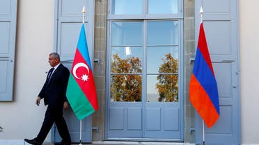 FILE PHOTO: A security guard walks past an Azeri (L) and Armenian flag at the opening of talks in Geneva, Switzerland, October 16, 2017. (Reuters)