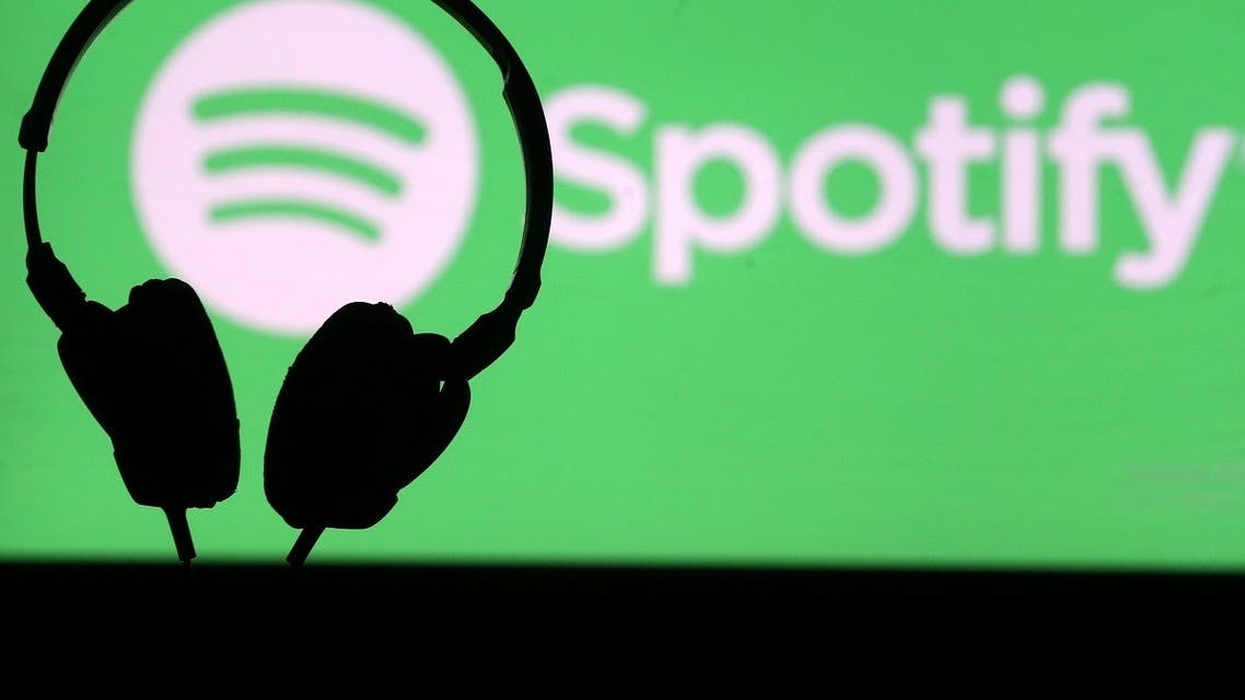 A headset is seen in front of a screen projection of Spotify logo, in this picture illustration taken April 1, 2018. (Reuters)