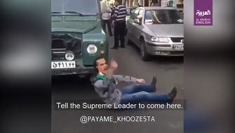 Watch: Angry Iranian lies in front of car in Mashhad, blames regime for hardship
