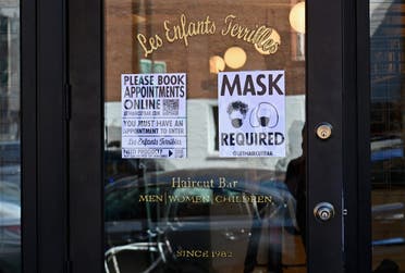 In this file photo a “Mask Required” sign is seen outside ‘Les Enfants Terribles’ hair salon and barber shop amid the coronavirus pandemic on June 22, 2020 in the Brooklyn Borough of New York City. (AFP)