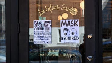 In this file photo a “Mask Required” sign is seen outside ‘Les Enfants Terribles’ hair salon and barber shop amid the coronavirus pandemic on June 22, 2020 in the Brooklyn Borough of New York City. (AFP)