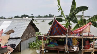 AP_20196An Indian flood affected boy stands on a makeshift platform near his partially submerged house in Gagolmari village, Morigaon district, Assam, India, Tuesday, July 14, 2020.  (AP)504992300