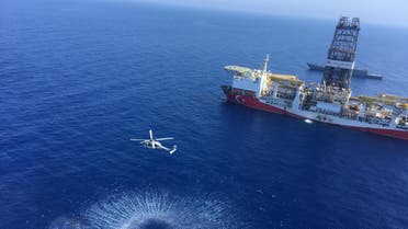A handout photograph taken and relased by the Turkish Defence Ministery on July 9,2019 shows a Turkish Navy warship patroling next to Turkey's drilling ship Fatih dispatched towards the eastern Mediterranean near Cyprus. Turkey will increase its activities off Cyprus after the EU approved measures to punish Ankara for drilling operations in the eastern Mediterranean, the Turkish foreign minister said on July 16, 2019.
