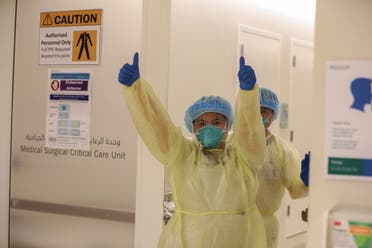 A member of medical staff wearing protective equipment gestures while entering the intensive care unit (ICU), amid the coronavirus disease (COVID-19) outbreak, at the Cleveland Clinic hospital in Abu Dhabi. (Reuters)