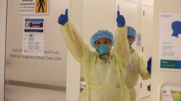 A member of medical staff wearing protective equipment gestures while entering the intensive care unit (ICU), amid the coronavirus disease (COVID-19) outbreak, at the Cleveland Clinic hospital in Abu Dhabi. (Reuters)