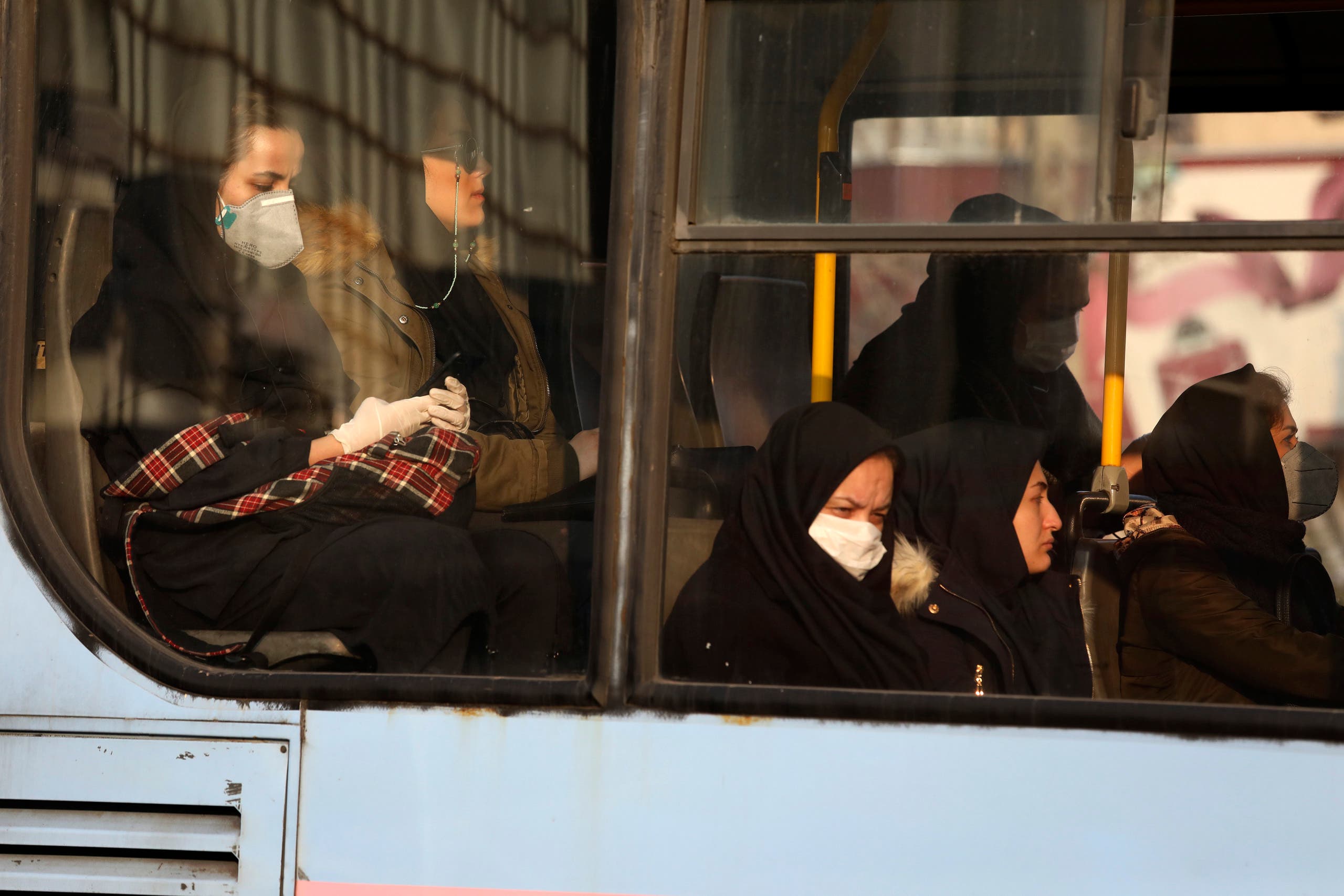 Woman, wearing face masks, on a public bus in a street in Tehran on Feb. 29, 2020. (File photo: AP)