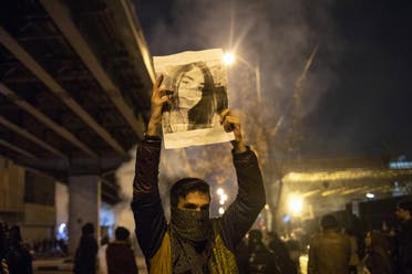 An Iranian man holds a picture of a victim of the Ukrainian plane downing during a demonstration in Tehran on January 11, 2020. (File photo: AP)