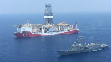 A handout photograph taken and relased by the Turkish Defence Ministery on July 9,2019 shows a Turkish Navy warship patroling next to Turkey's drilling ship Fatih dispatched towards the eastern Mediterranean near Cyprus. Turkey will increase its activities off Cyprus after the EU approved measures to punish Ankara for drilling operations in the eastern Mediterranean, the Turkish foreign minister said on July 16, 2019.