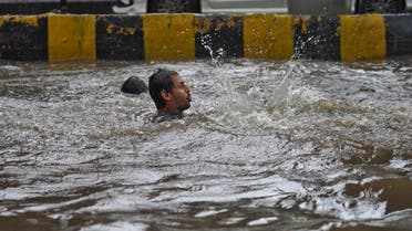 A man plays in a flooded road during heavy rains in Mumbai. (Reuters)