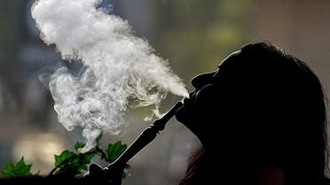 A woman smokes waterpipe (Shisha) at a cafe in Dubai on May 31, 2008. (AFP)