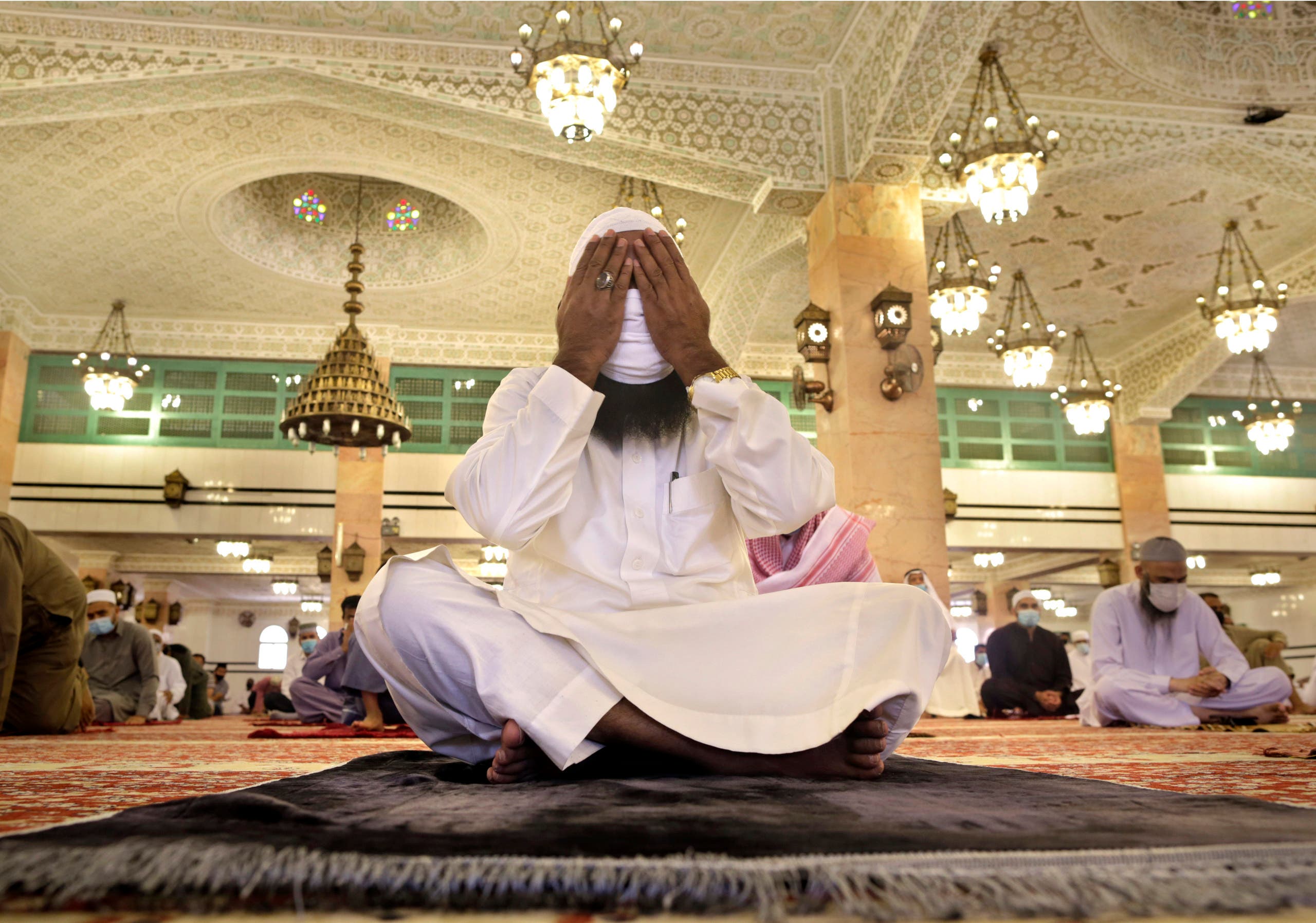 A Saudi worshipper wearing a face mask to prevent the spread of COVID-19, prays at the al-Mirabi Mosque in Jiddah, Saudi Arabia, Friday, July 10, 2020. (AP Photo/Amr Nabil)