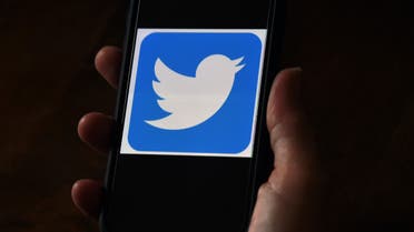 (FILES) In this file photo illustration, a Twitter logo is displayed on a mobile phone on May 27, 2020, in Arlington, Virginia. Twitter is probing a massive hack of high-profile users from Elon Musk to Joe Biden that has raised questions about the platform's security as it serves as a megaphone for politicians ahead of November's election.