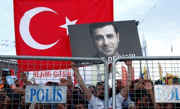 A file photo shows a supporter of Turkey's main pro-Kurdish Peoples' Democratic Party (HDP) holds a portrait of their jailed former leader and presidential candidate Selahattin Demirtas during a campaign event in Istanbul, Turkey, June 17, 2018. (Reuters/Huseyin Aldemir