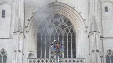 000_1VD8PUFirefighters are at work to put out a fire at the Saint-Pierre-et-Saint-Paul cathedral in Nantes, western France, on July 18, 2020. (AFP)