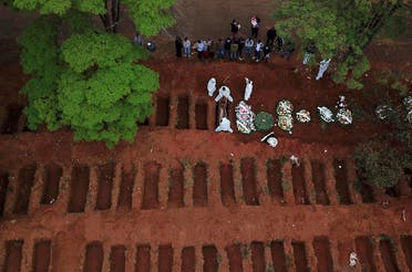 Gravediggers wearing protective suits bury a coffin at Vila Formosa cemetery during the outbreak of the coronavirus disease (COVID-19), in Sao Paulo, Brazil. (Reuters)