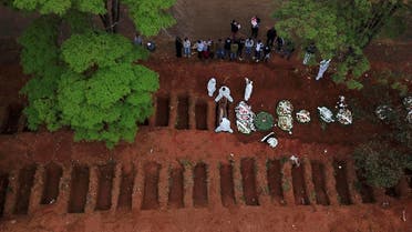 Gravediggers wearing protective suits bury a coffin at Vila Formosa cemetery during the outbreak of the coronavirus disease (COVID-19), in Sao Paulo, Brazil. (Reuters)
