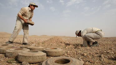 In this picture taken on Sunday, July 24, 2011, Iranian army members Hamzeh Nazeri, left, and Yasser Moazzami Goudarzi, prepare defused landmines to detonate during de-mining operations. (AP)