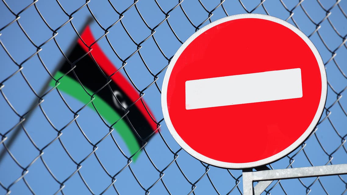 The flag of Libya behind the fence with the sign is forbidden stock photo