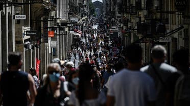 Pedestrians walk in a street lined with shops in Bordeaux, southern France, on July 19, 2020. (AFP)