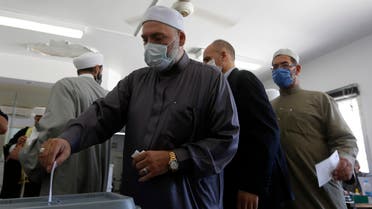 A Syrian cleric casts his ballot at a voting station in the capital Damascus on July 19, 2020. (AFP)