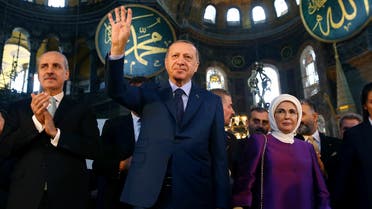 Turkey's President Recep Tayyip Erdogan, center, accompanied by his wife Emine, right, waves to supporters as he walks in the Byzantine-era Hagia Sophia on March 31, 2018. (AP)