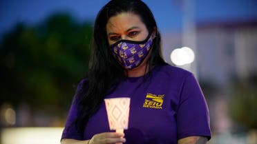 A healthcare worker holds up a candle during a vigil for healthcare workers amidst the coronavirus outbreak at St. Rose Dominican Hospital, Siena Campus, Thursday, April 30, 2020, in Las Vegas. (AP)