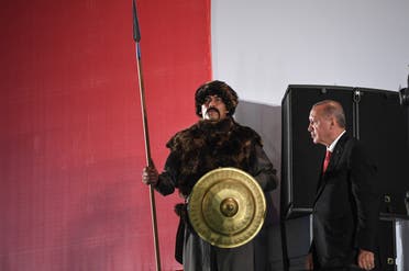 Turkish President Recep Tayyip Erdogan (R) passes next to a Turkish soldier wearing an Ottoman uniform during a third anniversary commemoration rally in Istanbul on July 15, 2019. (AFP)