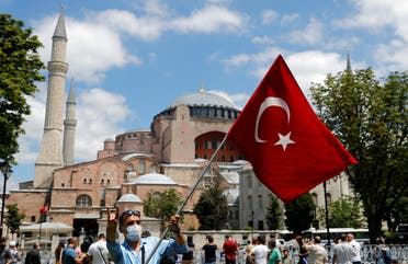 A man waves a Turkish flag as he makes the nationalist grey wolf sign in front of the Hagia Sophia in Istanbul on July 17, 2020. (Reuters)