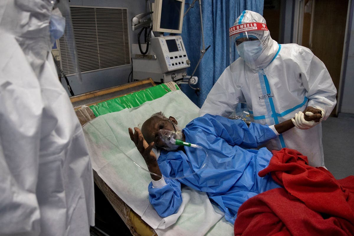 A file photo shows medical workers tend to a patient suffering from the coronavirus disease in the Intensive Care Unit at Lok Nayak Jai Prakash hospital, in New Delhi, India. (Reuters)