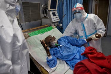 Medical workers wearing personal protective equipment (PPE) tend to a patient suffering from the coronavirus disease (COVID-19), in the Intensive Care Unit (ICU) at a hospital, in New Delhi, India July 17, 2020. (Reuters)