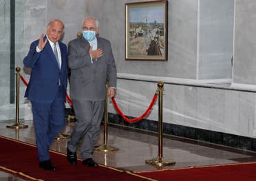 Iran's Foreign Minister Mohammad Javad Zarif walks with Iraqi Foreign Affairs Minister Fuad Hussain in Baghdad, Iraq, July 19, 2020. (Reuters)