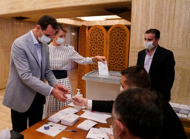 Syrian President Bashar Assad and his wife Asma vote at a polling station in the parliamentary elections in Damascus, Syria on July 19, 2020. (AP)