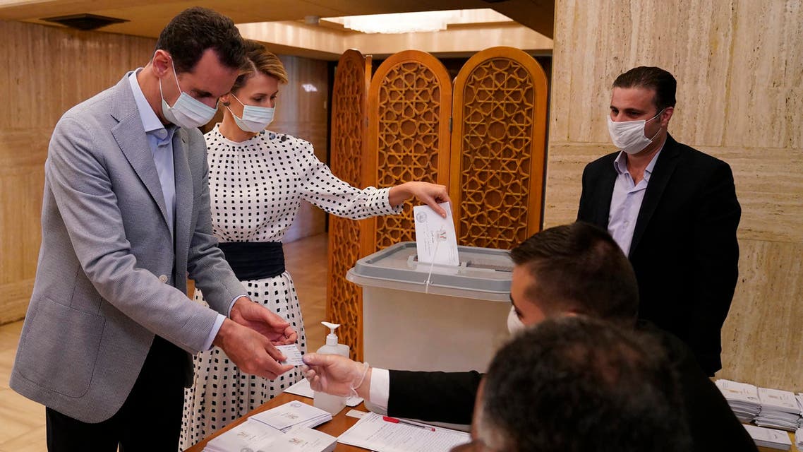 Syrian President Bashar Assad and his wife Asma vote at a polling station in the parliamentary elections in Damascus, Syria on July 19, 2020. (AP)