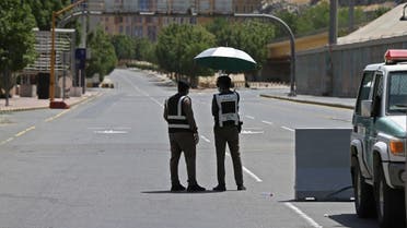 Police officers man a checkpoint in a street in Saudi Arabia's holy city of Mecca on April 3, 2020. (AFP)