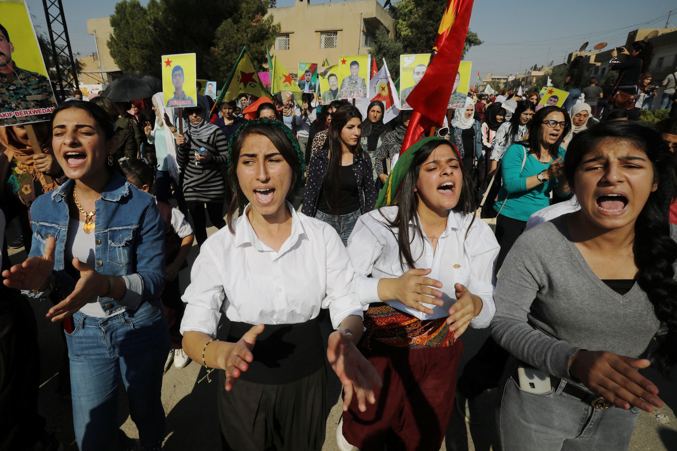 Kurdish and Arab protesters chant slogans against Turkish President Erdogan during a march to the United Nations Headquarters in the town of Qamishli, Syria. (Reuters)