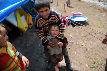 Kurdish children smile for the camera in Gurpinar district near Van on June 26, 2012. (AFP)