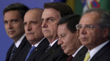 Brazil's President Jair Bolsonaro, center, stands next to the President of the Central Bank, Roberto Campos Neto, left, Chief of Staff Onix Lorenzoni, second left, Vice President Hamilton Mourao, second right, and the Minister of Economy, Paulo Guedes, right. (File photo: AP)