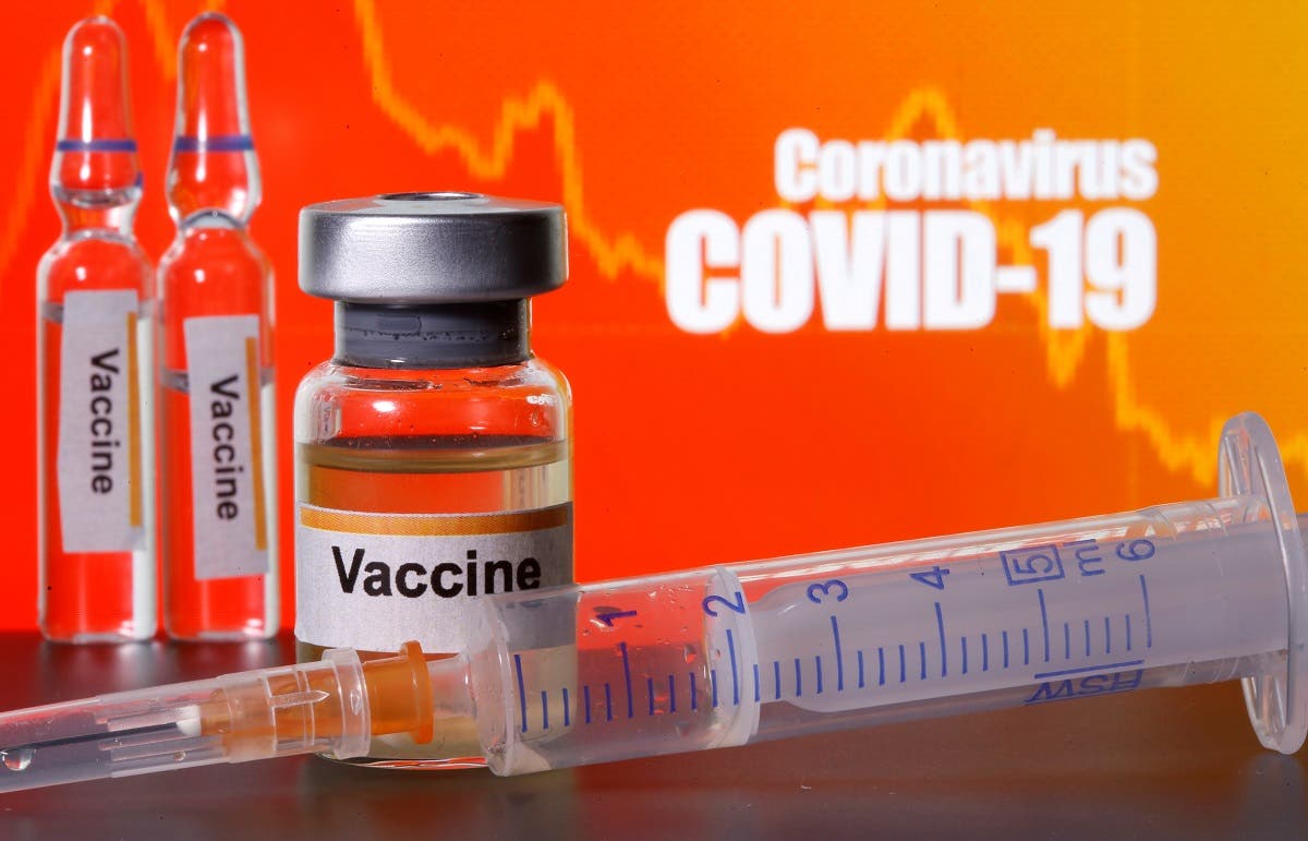 Small bottles labelled with “Vaccine’ stickers seen near a medical syringe in front of displayed “Coronavirus COVID-19” words in this illustration taken April 10, 2020. (Reuters)