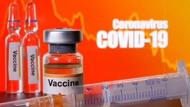 Small bottles labelled with “Vaccine’ stickers seen near a medical syringe in front of displayed “Coronavirus COVID-19” words in this illustration taken April 10, 2020. (Reuters)