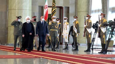 Iranian President Rouhani and Iraqi PM al-Kadhimi walk during a welcome ceremony, as they wear protective masks, in Tehran, Iran, July 21 2020. (Reuters)