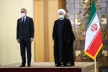 A handout picture provided by the Iranian presidency on July 21, 2020, shows the mask-clad President Hassan Rouhani (R) receiving Iraq's Prime Minister Mustafa al-Kadhimi (L) in the capital Tehran.