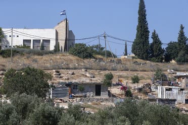 A picture taken from the Palestinian village of Al-Issifer shows a building in the Israeli settlement of Yattir overlooking the village, south of Yatta town, in the occupied West Bank, on July 12, 2020. (File photo: AFP)