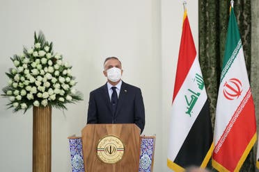 Iraqi Prime Minister Mustafa al-Kadhimi attends a news conference with Iranian President Hassan Rouhani as he wears a protective mask, in Tehran. (Reuters)