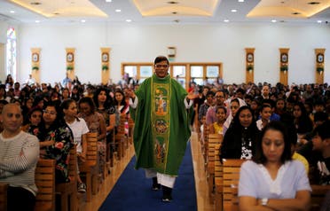 A Catholic bishop walks between the worshippers during the mass at St. Francis of Assisi Catholic Church in Dubai, UAE on January 18, 2019. (Reuters)