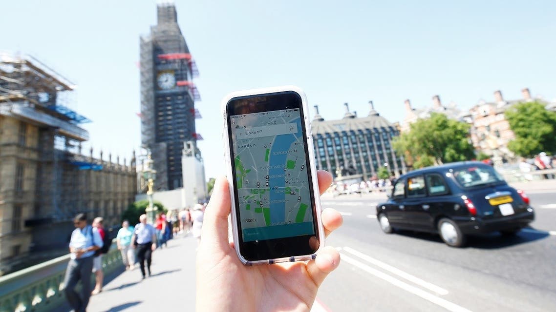 A photo illustration shows the Uber app and a black cab in London, Britain. (Reuters)