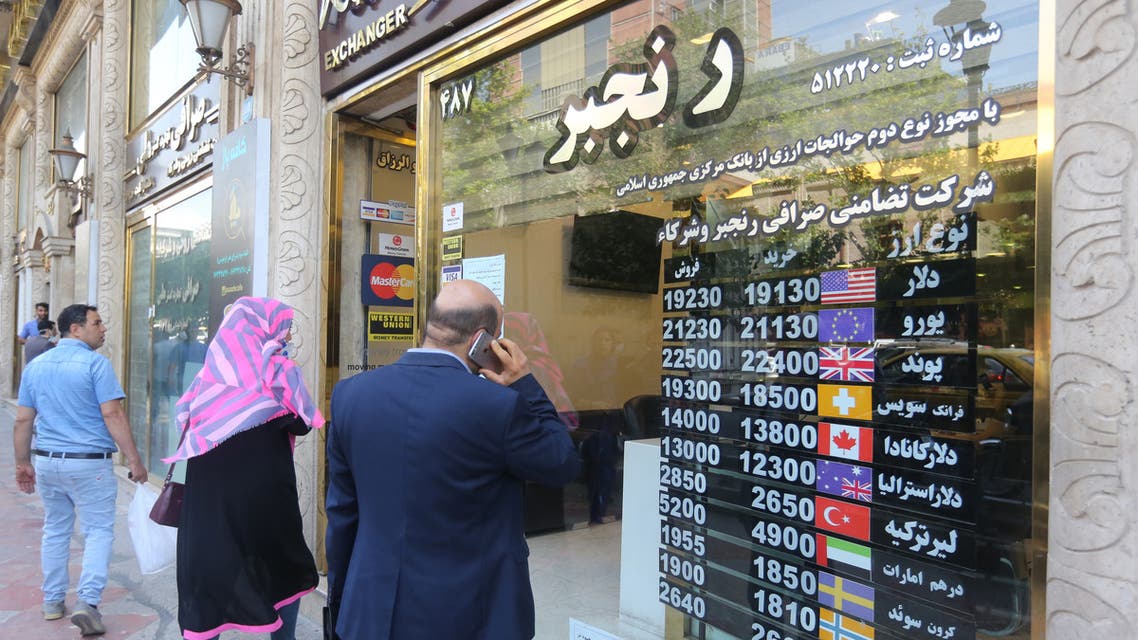 Iranians wait outside a money exchange office in Tehran amid the ongoing COVID-19 pandemic, on June 22, 2020.