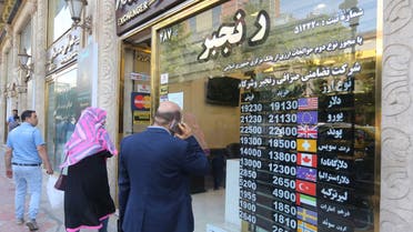 Iranians wait outside a money exchange office in Tehran amid the ongoing COVID-19 pandemic, on June 22, 2020. 